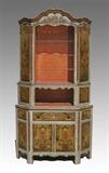 Lot 1051:  SWEDISH PAINT DECORATED CORNER CABINET: Profusely paint decorated with floral motifs. Shaped top over 2 open sections, top section with 2 additional doors. Base with single drawer over 2 doors, surmounted by 2 additional doors either side. 100 3/4'' h. x 54'' x 23''.
CONDITION: Wear consistent with age and use.