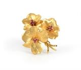 Lot 1081:  TIFFANY & CO RUBY BROOCH: 18K yellow gold floral motif brooch having 9 round shaped mixed cut rubies totaling .45 Ct. Signed ''Tiffany & Co. 18K Italy'' Length: 2''. Weight 13.7 grams. Sold with current Atlanta Gemological GIA graduates appraisal for $3250. Est. $1510/3000**