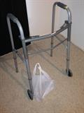 Lot #46 
Adjustable walker on wheels with extra brand new parts for legs.
