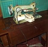 Antique sewing machine with cabinet.
