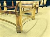 CLOSE-UP OF GLASS-TOP BRASS TABLE