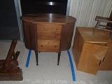 Sewing Cabinet 	 

Labeled The New Martha Washington Table by Miller Cabinet Company, patented 1917. Three drawers, two side compartments that swing out. Two dowels for thread spools. Removable tray container. Small stains to surface top. 27X14X27. 	

	
http://auctionnearyou.maxsold.com/view-auctions/catalog/id/378/lot/41027/?url=%2Fview-auctions%2Fcatalog%2Fid%2F378%2F%3Fpage%3D1%26items%3D100

