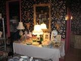 lots of collectibles , Wedgewood , pressed glass , etchings, many other good items on this table.