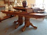Double pedestal golden oak dinning table. 4ft x 6 ft, 2 leaves 24 inches wide each, ten (10) chairs.