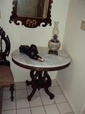 Eastlake style marble top center table, oil lamp and Doberman dog