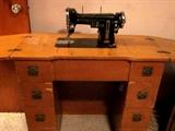 Vintage Necchi sewing machine in cabinet