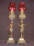 314 - Matched pair of Victorian banquet lamps with figures of ladies and cranberry shades, 36in. T.