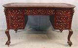 368 - Mahogany partners desk with 14 drawers and carved top with griffins in the style of Horner, 31in. T, 56in. W, 36in. D.