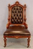 525 - Walnut Victorian parlor chair with lions heads and gold sizing with leather upholstery, att. to John Jeliff, 43in. T, 24in. W, 22in. D.