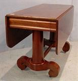 526 - Solid mahogany empire drop leaf library table with end drawers and scroll feet, round column base, 29in. T, 42in. W, 19in. D.