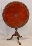 533 - Mahogany tilt top Queen Ann tea table with carving on band and spade feet, 29in. T, 28in. Dia.