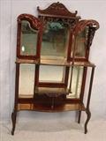 538 - Mahogany Victorian etagere with pierced carving on crown, original beveled mirror, 62in. T, 36in. W, 11in. D.