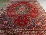 548 - Hand made Persian rug, red, blue, green and white, 9ft 5in x 12ft 11in.
