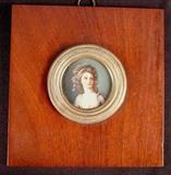 180 - Ivory in round wooden frame with brass trim, artist signed, 6.5in. X 6.25 frame.