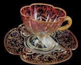 239- Moser glass demitasse cup and saucer, cranberry cut to clear with lots of gold applied.