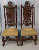 249 - Pair of pierced carved hall chairs, 53in. T, 20in. across.