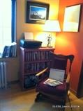 Antique Platform Rocker, Epson printer, lamp, books, bookshelf 