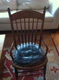 Antique spindle back chair (short back). Cane seat covered in black leather (two of two.)