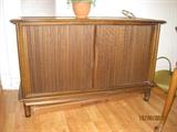 Retro cabinet with doors that slide into the side walls.