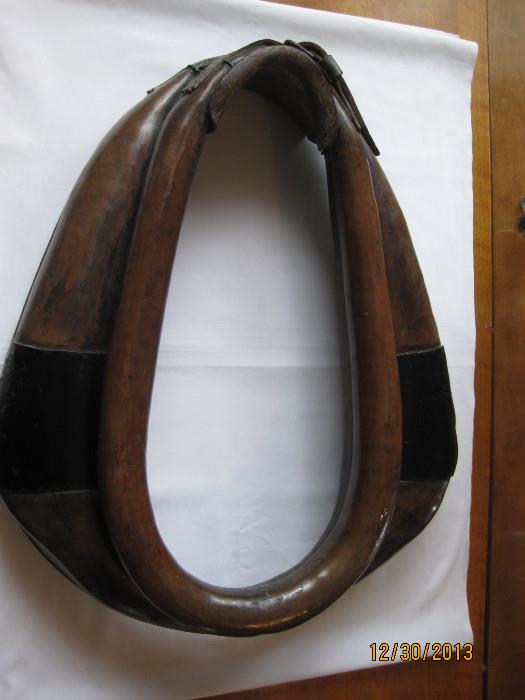This horse collar/hames was my grandfather's from the early 1900's, of which my father used as well.  All leather with buckles at the top and wood trim.  It's in very good condition.
