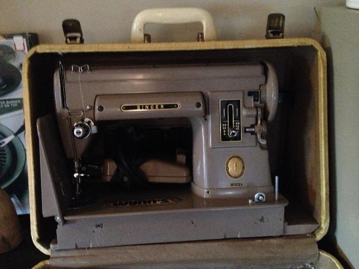 Old metal Singer sewing machine in carrying case.