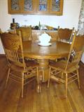 Newer oak pedestal claw foot table and 4 chairs