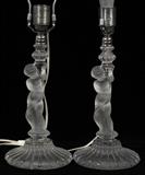 Lot#1013, BACCARAT CRYSTAL FIGURAL LAMPS, PAIR, H 10 1/2" (19" OVERALL)Candlestick style frosted and molded base in the form of a putto holding cornucopia, H.10 1/2", signed, with crystal finials.  Measures H.19" overall.