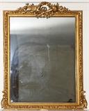 Lot#1038, FRENCH STYLE GILT WOOD MIRROR, 58" X 46" OVERALL,Hand carved, gold leaf and gilt. Crest carved in motif of wreath, crossed torches, garlands. Circa 1900.