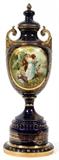 Lot#1069, ROYAL VIENNA BLUE PORCELAIN COVERED URN WITH COURTING RESERVE, H 22 1/2", W 7",Printed scene in the style of Sevres. Fired gold highlights and handles.  Cobalt blue ground.  #5205 on underside along with a blue beehive mark and a crown made in Austria Royal Vienna mark.