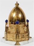 Lot#1099, THEO FABERGE STERLING & 22KT GOLD 'THE KIEV EGG' H 6 1/2", ENCASED,In original box. Hallmarks: rampant lion, leopard head, date letter "U" for 1994. . Limited edition #19/750. inspired by the elegance and architectural beauty of the cathedrals and churches in the city of Kiev. A sterling silver Egg surmounted by the Imperial Crown, enriched with 24 carat gold and cobalt blue enamel, rests on a white marble base. The intricate towers reaching for the sky. Inspired by the elegance and architectural beauty of the cathedrals and churches in the city of Kiev. A sterling silver Egg surmounted by the Imperial Crown, enriched with 24 carat gold and cobalt blue enamel, rests on a white marble base. The intricate towers reaching for the sky.