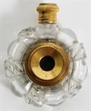 Lot#1232, CONTINENTAL CRYSTAL QUARTZ SCENT BOTTLE WITH SPY GLASS, LATE 19TH C., L 2"Colorless quartz scent bottle inset with a three-drawer brass spy glass, surmounted by a threaded cap opening to stopper.  No apparent markings.  Measures L.2", W.1 3/4".
