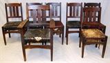 Lot#1393, GUSTAV STICKLEY DINING CHAIRS, SET OF SEVEN, C. 1900,Oak, vertical slats. Six side style and one open arm. All have Stickley branded trademark. Upholstered seats.