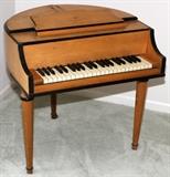 Lot#1401, THE RUDOLPH WURLITZER CO. 'STUDENT BUTTERFLY PIANO', H 30", W 30", D 30"Child size; practice or beginner piano; birch wood case.  Made by the Rudolph Wurlitzer Co.
