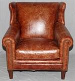 Lot#2411, DREXEL HERITAGE LEATHER WINGBACK CHAIR, H 37.5", L 36"A wingback arm chair in brown leather.