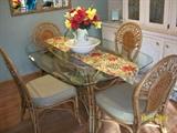 Rattan and Glass dining table with 4 chairs.