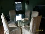 Double pedestal glass topped dining table with 6 chairs.