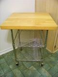 Rolling cart with butcher block top.