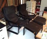 Pair of IKEA black leather lounge chairs with ottomans