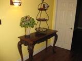 Lovely Orante Sofa Table, Silk Plant, and Large Three Tier Dessert Stand