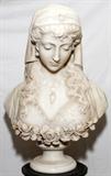 Lot#1008, R. BATTELLI (19TH/20TH C.), ITALIAN MARBLE ORIENTALIST BUST, H 22", W 15"Carved as a beautiful young woman wearing a head scarf and coin necklace, gazing downward, and roses at her bodice, raised on a socle base; signed on the reverse (see additional photo).