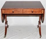 Lot#1044, ENGLISH MAHOGANY SOFA TABLE, C. 1900, H 27", W 34" CLOSED,Having line inlaid drawer fronts and legs, with inlaid floral decoration at each end. On casters with brass hardware, wooden drawer pulls, and drop leaves. Drop leaves measuring L 12".