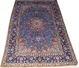 Lot#1052, ISFAHAN RUG, 8' 0" X 5' 0"Bright blue ground with central medallion and flowering vines overall, within multiple floral borders.