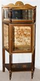 Lot#1132, FRENCH STYLE PAINTED MAHOGANY CURIO CABINET, H 57", W 32", D 12"A mirrored top above a single door fitted with beveled glass, raised on fluted tapering legs joined by a shelf stretcher.  Mid 20th century.