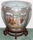 Lot#1176,CHINESE ROSE MANDARIN STYLE PORCELAIN FISH BOWL, H 20", DIA 24", Decorated with court scenes on a bird and butterfly ground, stamped six-character mark underneath, raised on a separate wood base, H.28" overall.