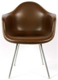 Lot#1232, CHARLES EAMES FOR HERMAN MILLER SHELL ARMCHAIR,Brown fiberglass shell-form with brown naugahyde, on metal leg base.  Marked at the underside (see additional photo).  Measures H.32" x 25" x 27".  Circa 1960.