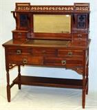 Lot#1247, CHERRY DESK, C. 1880-1900, H 46", W 39", D 20"Cherry desk with slide out writing surface, curio shelf, and nine drawers. Raised on high legs, beveled mirror.