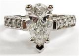 Lot#2030, 3.00 CT. DIAMOND AND PLATINUM ENGAGEMENT RING,Having a large 2.00 ct. pear shape diamond, brilliant cut, 11.12mm L. x 6.93mm W. x 4.56mm D., 'G' color, 'SI2' clarity.  Along with 60 small brilliant cut diamond enhancements weighing approximately 0.01-0.04 cts each totaling approximately 1.00 cts total, having 'G-H' color and 'VS2' clarity all mounted in a platinum setting stamped 'PL' and weighing approximately 5.4 DWT. Includes a GIA certificate dated February 2000 and an appraisal dated July 2013.