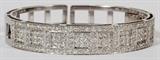 Lot#2065, 6.50CT PRINCESS CUT DIAMOND MODERN BANGLE BRACELET, 35.4GR,18kt white gold ladies bangle bracelet, featuring 6.50 carats of diamonds; having a total approximate weight of 35.4 grams.