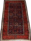 Lot#2079, BALOCHISTAN WOOL RUG, 33' X 61"Having a red ground with navy, white and black diamond designs, one large primary border flanked by five narrow borders.