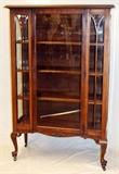 Lot#2320, QUEEN ANNE STYLE CURIO CABINET, H 63'' L 41''Raised on cabriole legs with casters, having a glass paneled front, with center door; brass key opening to an interior fitted with three shelves. Measures H. 63" x 41" x 16".